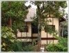 New Lao classic house by Namkan River and frontage next to pave road in city of Luangprabang